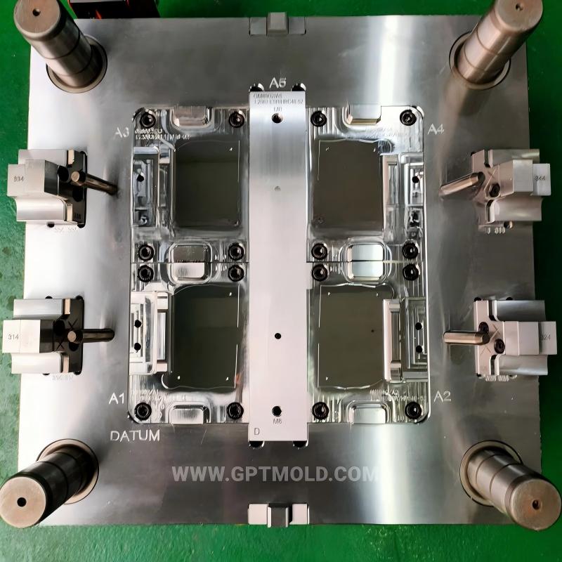 Open injection mold showing four cavity areas